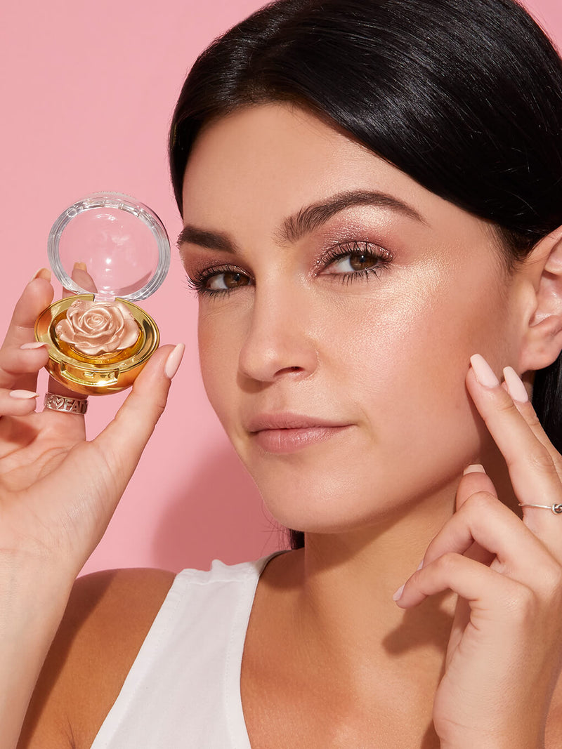 Champagne -- cheeky rose cream highlighter in rose design on white background