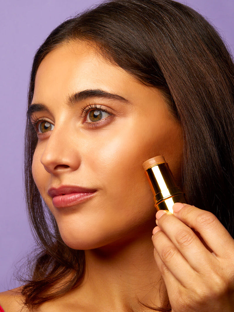 Golden Touch -- bronze age cream bronzing stick on white background