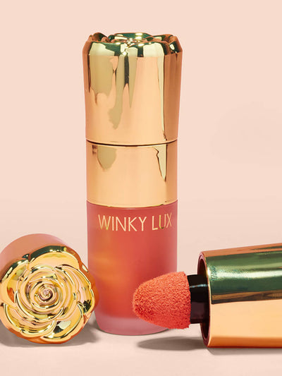 Darling -- cheeky rose liquid blush with caps laying next to