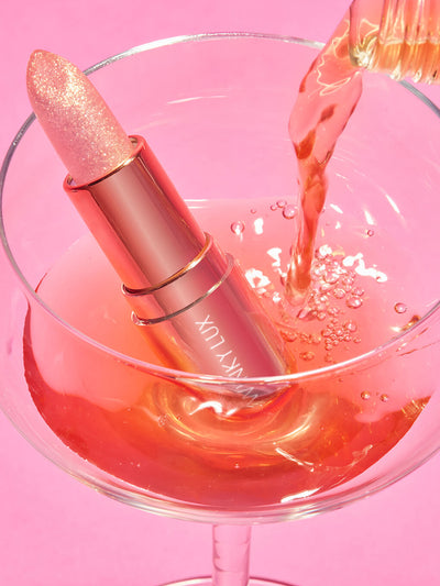 Rosé glimmer -- rosé glimmer ph balm in a glass with Rosé pouring in