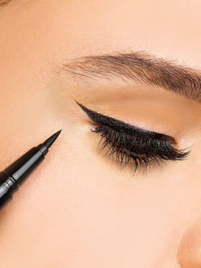 Black -- close up of brunette model wearing meowza liquid eyeliner