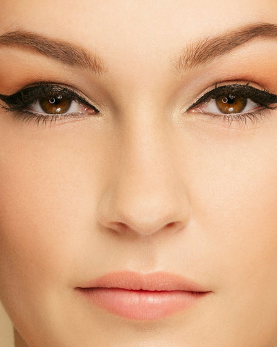 Black -- close up of brunette model wearing meowza liquid eyeliner
