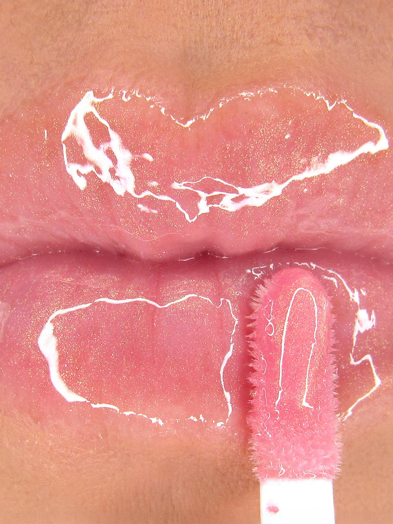 Pink opal shimmer -- nourishing golden pink lip oil with cap off on white background
