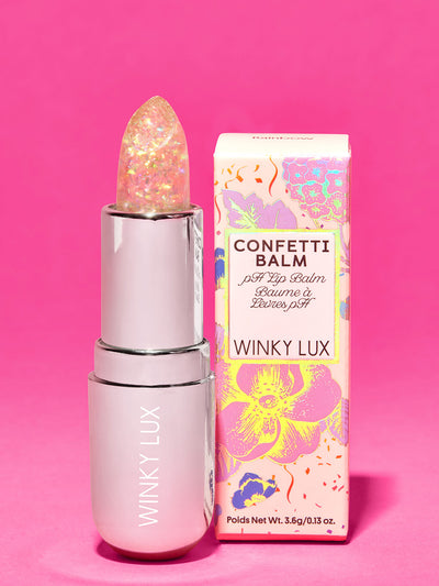 rainbow confetti -- glitter confetti ph balm standing next to box on pink background