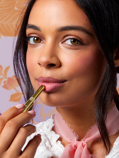 corner office -- close up of brunette model applying skinny plump demi matte plumping lipstick