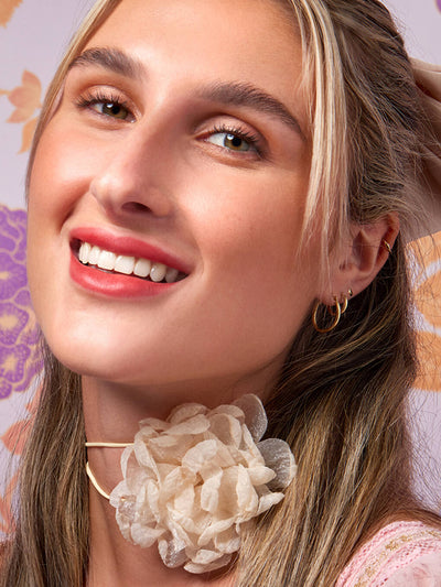 first crush -- close up of blonde model smiling wearing skinny plump demi matte plumping lipstick