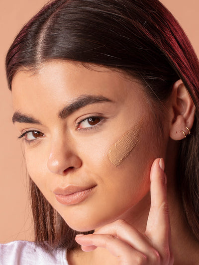 Medium -- close up of brunette model with tinted moisturizer spf 30 on her cheek bone