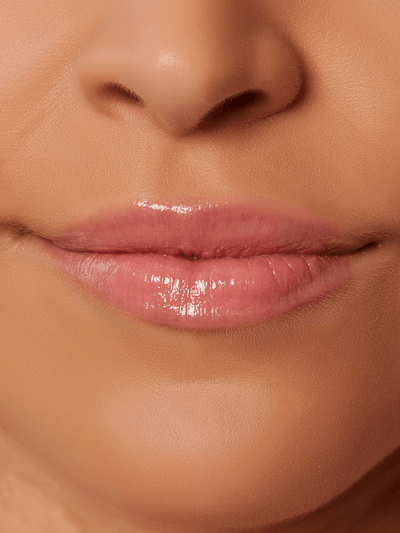 Muse -- close up of models lips wearing Muse baby pink tinted lip oil