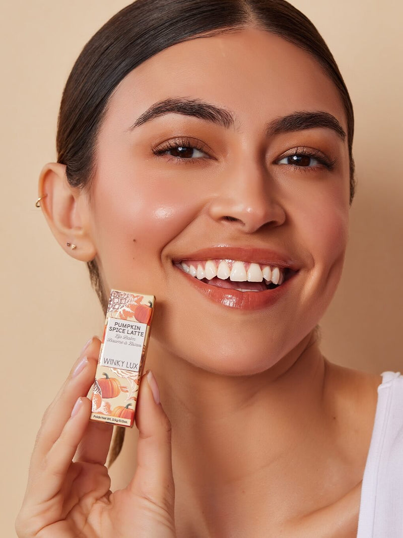 Pumpkin spice latte lip balm with cap off on white background
