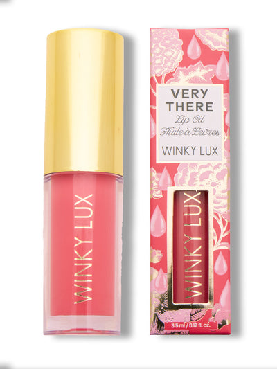Juicy -- bright pink lip oil next to box on white background