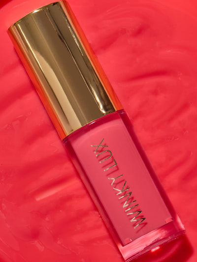 juicy -- close up of pink lip oil component lying on top of lip oil goop