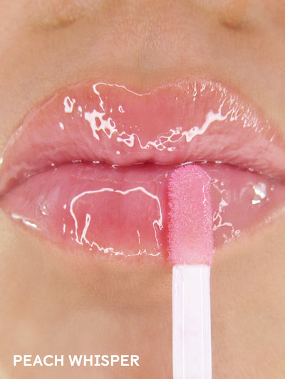 peach whisper -- close up of applicator applying peach lip oil to lips