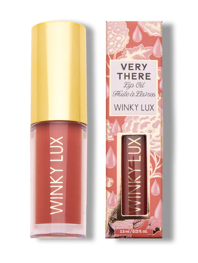 swoon -- pink tinted lip oil next to box on white background