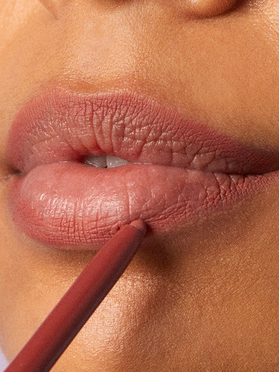 meow -- close up of brunette model applying waterproof lip liner