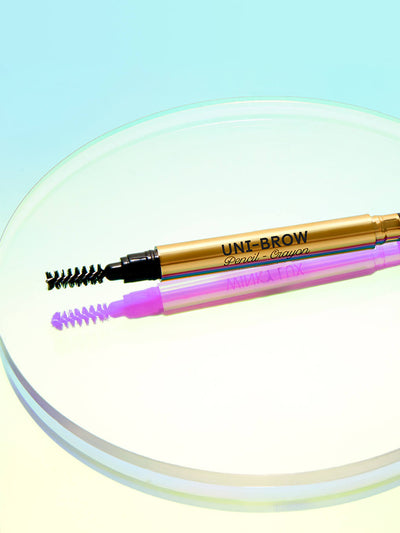 stylized image of unibrow universal brow pencil laying flat on circular prop